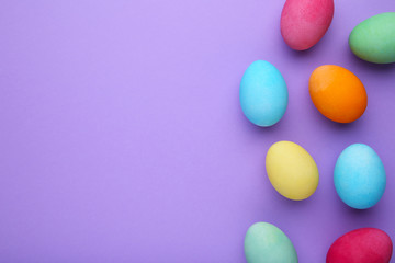 Fototapeta na wymiar Colorful easter eggs on a purple background