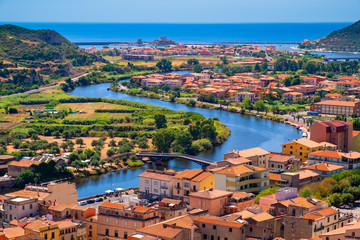 Fototapeta na wymiar Sardinia, Italy - Panoramic view of the town of Bosa by the Temo river with Bosa Marina resort at the Mediterranean sea coast seen from Malaspina Castle hill - known also as Castle of Serravalle