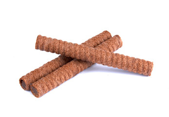 Waffle rolls with chocolate cream on white background