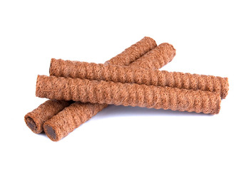 Waffle rolls with chocolate cream on white background