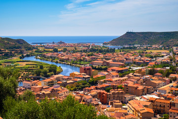 Sardinia, Italy - Panoramic view of the town of Bosa by the Temo river with Bosa Marina resort at...