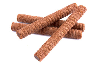 Waffle rolls with chocolate cream on white background