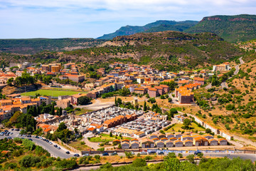 Fototapeta na wymiar Sardinia, Italy - Panoramic view of the town of Bosa and surrounding hills seen from Malaspina Castle hill - known also as Castle of Serravalle