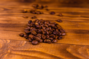 Pile of the coffee beans on wooden table
