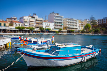 Fototapeta na wymiar Boats in the harbor of Agios Nikolaos, the most picturesque city in Crete
