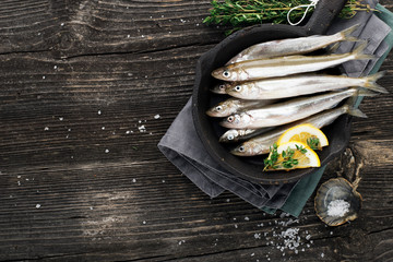 Seafood. Small sea small fish smelt, anchovies, sardines in the form for cooking with oil, salt and...