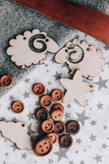 Wooden toy silhouette lamb, star, month, mountain, cactus, Christmas tree on grey background.