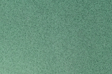 Fototapeta premium Green rubber covering for sports and playgrounds.