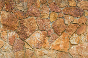 backgrounds, texture wall is covered with natural red stone. Pattern of decorative stone wall background. Stone wall texture. random size stone wall.Background of stone wall, concrete connection.