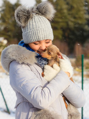 Woman playing with dog during winter