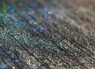 The unfocused background of the silver glitter of water droplets on the black for text, banner, poster, label, sticker, layout.