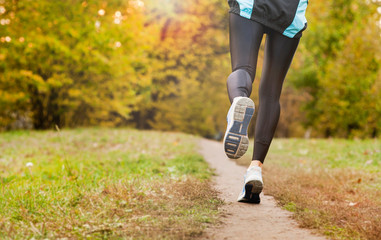 running along a park path, healthcare and problem concept - close-up of an unhappy person suffering from pain in the leg or knee outdoors