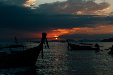 Long tail traditional boats moored, sunset twilight Ao Nang, Krabi Province, with limestone islands in the background, Krabi, Thailand, Southeast Asia.