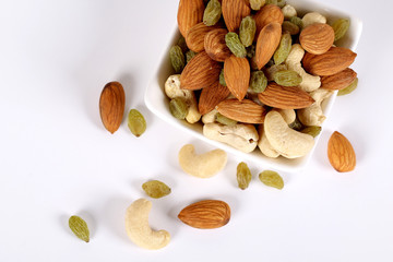 ssorted nuts on white, dry fruits, mix nuts, almond, cashew,  raisin