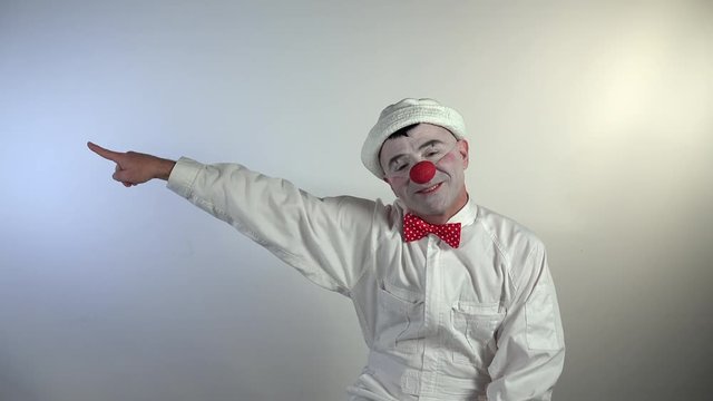 Emoji Clown. A funny clown becomes mad during he indicates with his hand the expulsion of someone insistently by helping himself with a megaphone.