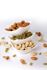 ssorted nuts on white, dry fruits, mix nuts, almond, cashew,  raisin