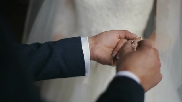 The groom puts the wedding ring on finger of the bride. marriage hands with rings. The bride and groom exchange wedding rings.
