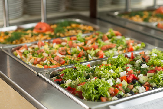 Fresh salads in boilers on the buffet table