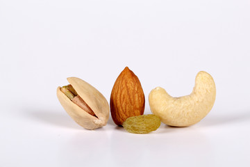 ssorted nuts on white, dry fruits, mix nuts, almond, cashew, pistachio, raisin