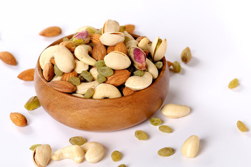 ssorted nuts on white, dry fruits, mix nuts, almond, cashew, pistachio, raisin