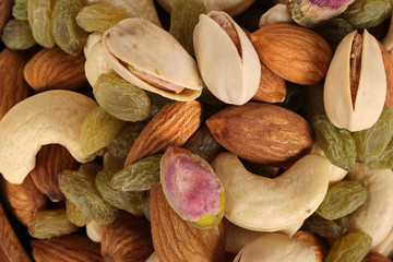 ssorted nuts on white, dry fruits, mix nuts, almond, cashew, pistachio, raisin