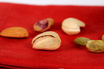 ssorted nuts on white, dry fruits, mix nuts, almond, cashew, pistachio, raisin