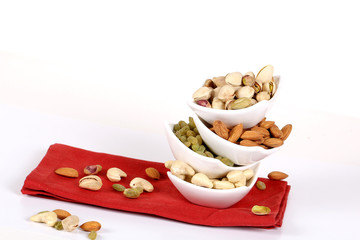 ssorted nuts on white, dry fruits, mix nuts, almond, cashew, pistachio, raisin