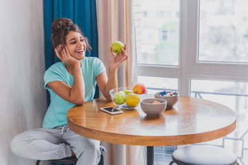 Beautiful, calm young woman with a cup of coffee, relaxing hot drink, happy lady holding a cup. Pretty brunette. The girl is sleepy. Food and drink.