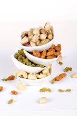 ssorted nuts on white, dry fruits, mix nuts, almond, cashew, pistachio, raisin