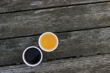 Fototapeta na wymiar cup of juice on wooden table, yellow, deep red