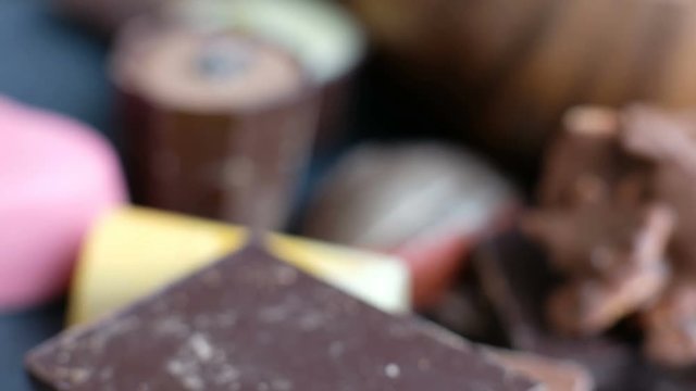 Kid chosing assorted chocolate from box tasty dessert background. Macro, close-up