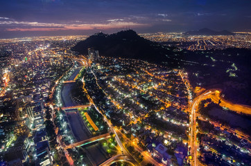 Night view of Santiago de Chile toward the east part of the city, showing the Mapocho river and...