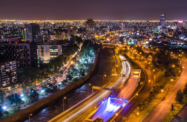 Fototapeta na wymiar Night view of Santiago de Chile toward the east part of the city, showing the Mapocho river and Providencia and Las Condes districts