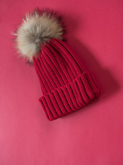 Red wool hat on red background