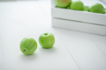 fresh green apples in a box on white background