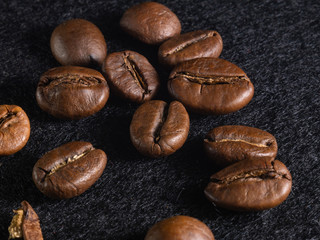 Focus on a single coffee bean on a background of many grains of coffee