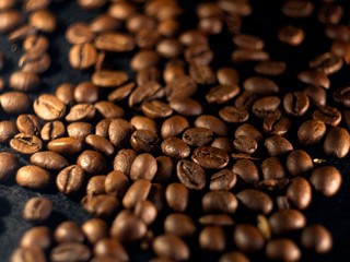 Focus on a single coffee bean on a background of many grains of coffee