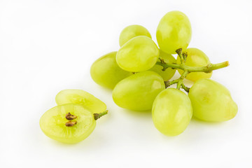 Grape berries and a small branch on white background
