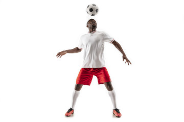 Professional african american football soccer player in motion isolated on white studio background. Fit jumping man in action, jump, movement at game.