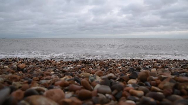 Gentle waves coming towards camera on the beach at Felixstowe, Suffolk