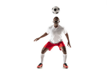 Professional african american football soccer player in motion isolated on white studio background. Fit jumping man in action, jump, movement at game.