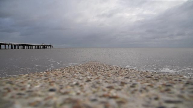 Waves breaking each side of concrete groyne at Felixstowe