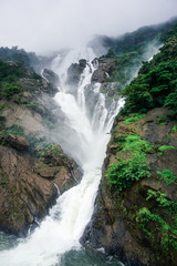 The huge waterfall Dudsagar in the wild jungle. Karnataka, India