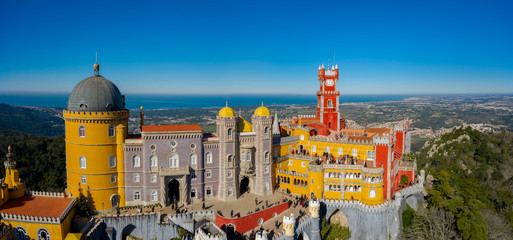Aerial view of Pena Palace, castle stands on Sintra Mountains; monument and one of the Seven...