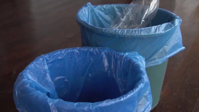 Plastic bottles and paper are thrown into different recycle bins and there are waste separation bins for different kind of garbage to safe environment. Home waste management concept