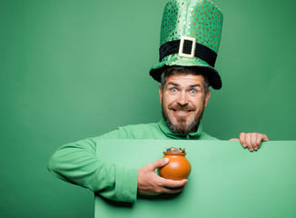 Green patricks background. Man in Patrick's suit smiling. Man in Saint Patrick's Day leprechaun...