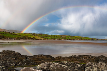 Scenic irish beach landscape rainbow reflection, the wild atlantic way on west coast of Ireland