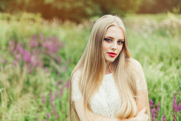 Naklejka premium Close up natural portrait of young happy cute cheerful caucasian beautiful girl witn long natural blondie hair walking in park in summer evening