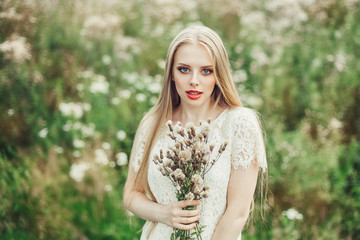 Fototapeta premium Close up natural portrait of young happy cute cheerful caucasian beautiful girl witn long natural blondie hair walking in park in summer evening