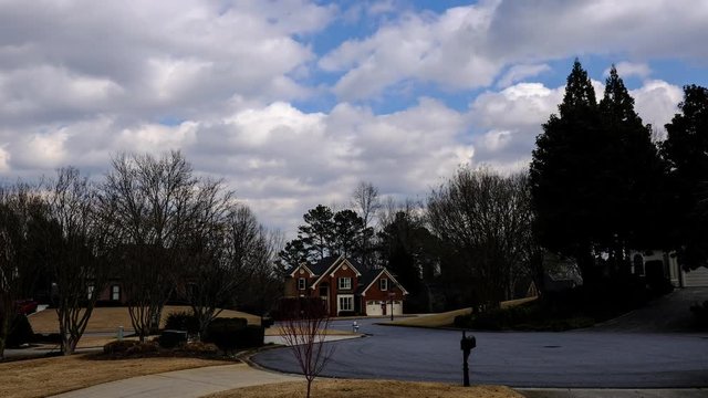 ATLANTA, GEORGIA, USA - JANUARY 2019: A typical american suburban neighborhood at sunny day. Time lapse video